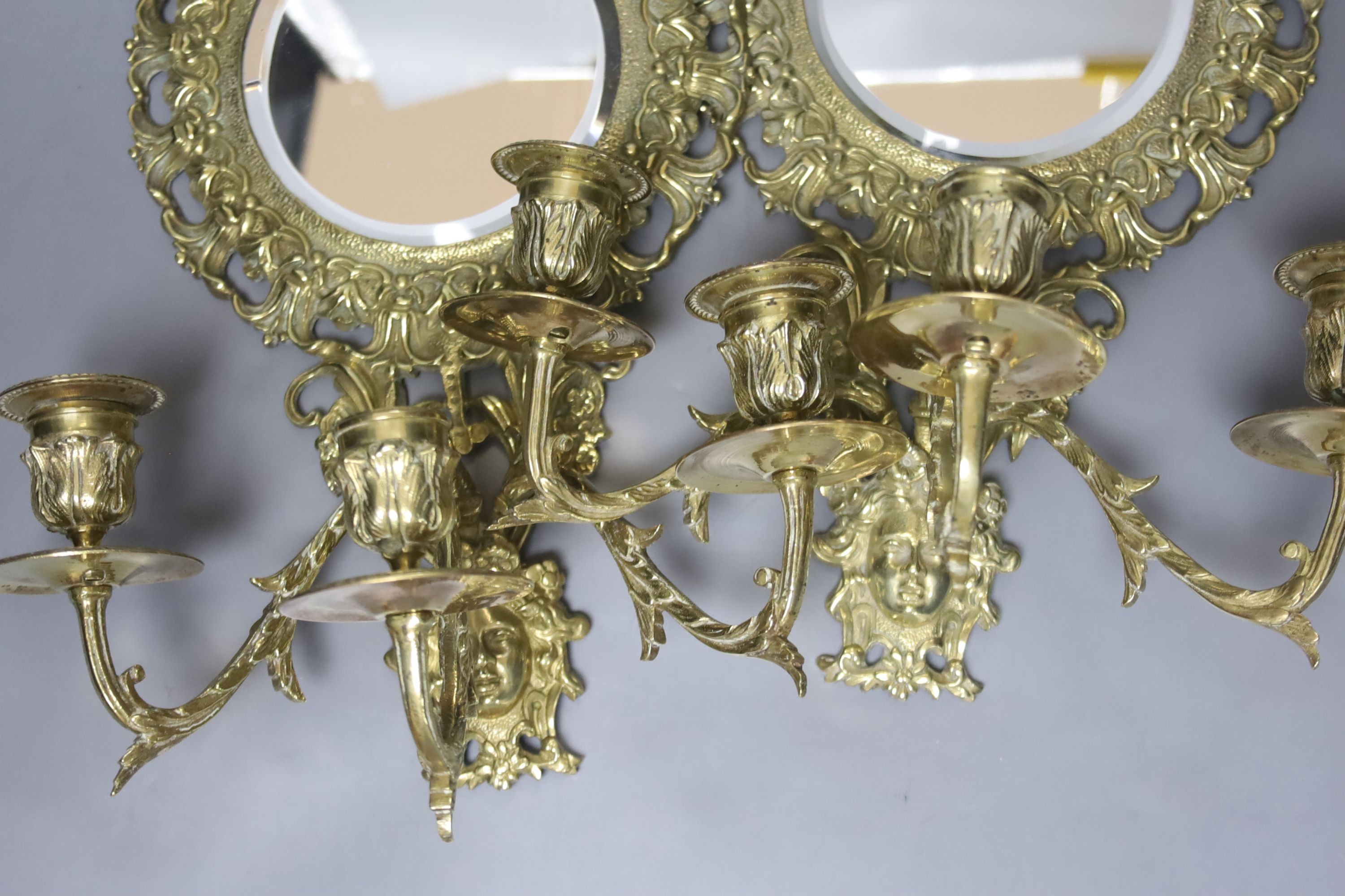 A pair of late 19th century French cast brass three sconce girandoles, height 42cm